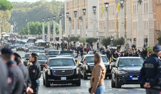 Police officers stand by as the motorcade of President Joe Biden arrives across the Via della Conciliazione in Rome leading to the Vatican on Friday for Biden's meeting with Pope Francis.