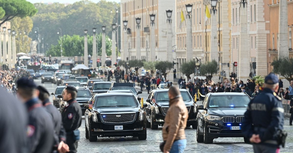 Police officers stand by as the motorcade of President Joe Biden arrives across the Via della Conciliazione in Rome leading to the Vatican on Friday for Biden's meeting with Pope Francis.