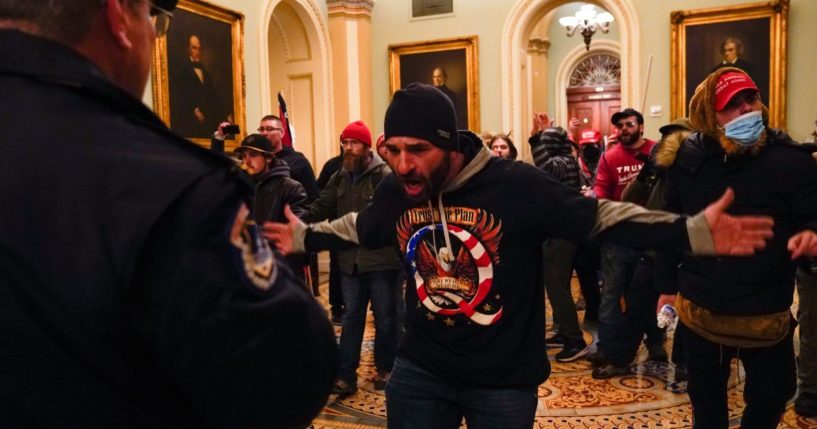 Protesters confront U.S. Capitol Police officers in the hallway outside of the Senate chamber during the Capitol incursion in Washington on Jan. 6, 2021.