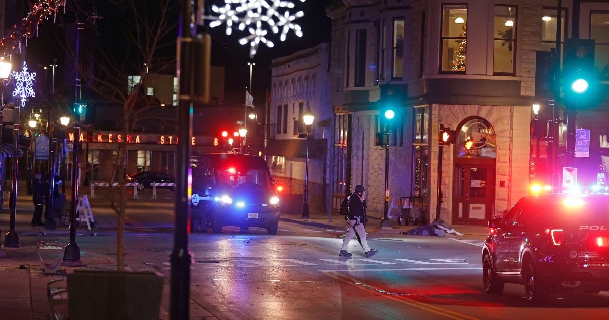 Police canvass the streets in downtown Waukesha, Wisconsin, after a vehicle plowed into a Christmas parade hitting more than 20 people on Sunday.