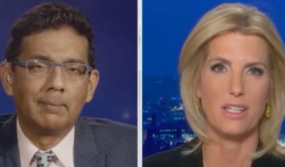 Political commentator Dinesh D'Souza, left, appears on the Fox News show "The Ingraham Angle" hosted by Laura Ingraham, right, to discuss the Christmas parade massacre in Waukesha, Wisconsin, and the media's response to it.
