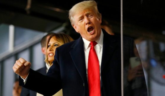 Former President Donald Trump waves prior to game four of the World Series between the Houston Astros and the Atlanta Braves at Truist Park on Oct. 30 in Atlanta.