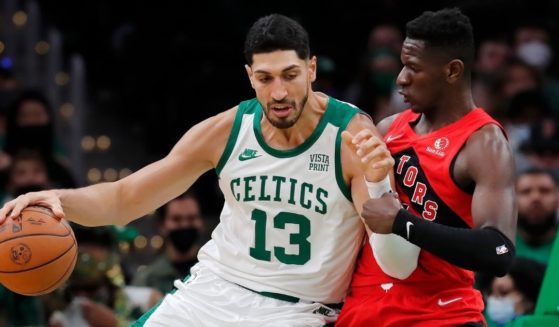Boston Celtics center Enes Kanter moves against the Toronto Raptors' Isaac Bonga during a game at TD Garden on Oct. 22.