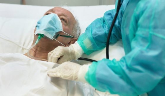 This stock image shows an elderly man with an oxygen mask on lying in the hospital. A German euthanasia organization is refusing clients who have not been vaccinated against COVID-19.