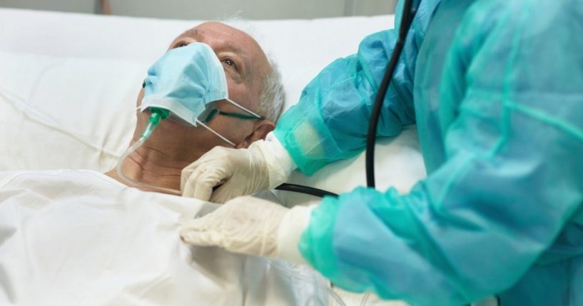 This stock image shows an elderly man with an oxygen mask on lying in the hospital. A German euthanasia organization is refusing clients who have not been vaccinated against COVID-19.