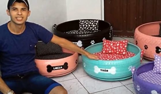 Amarildo Silva Filho of Brazil shows off some of his dog beds made from tires.