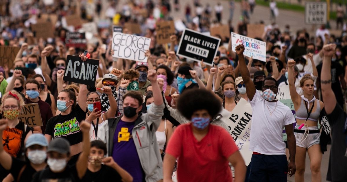 Demonstrators march on Hiawatha Avenue in Minneapolis on May 26, 2020, to decry the death of George Floyd in police custody.