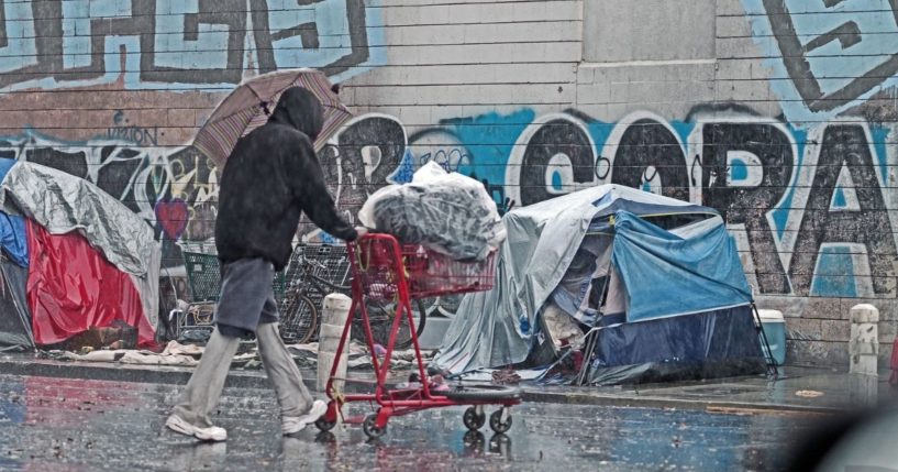 A homeless person is seen on the street during a rain storm on Oct. 25 in Los Angeles, California.
