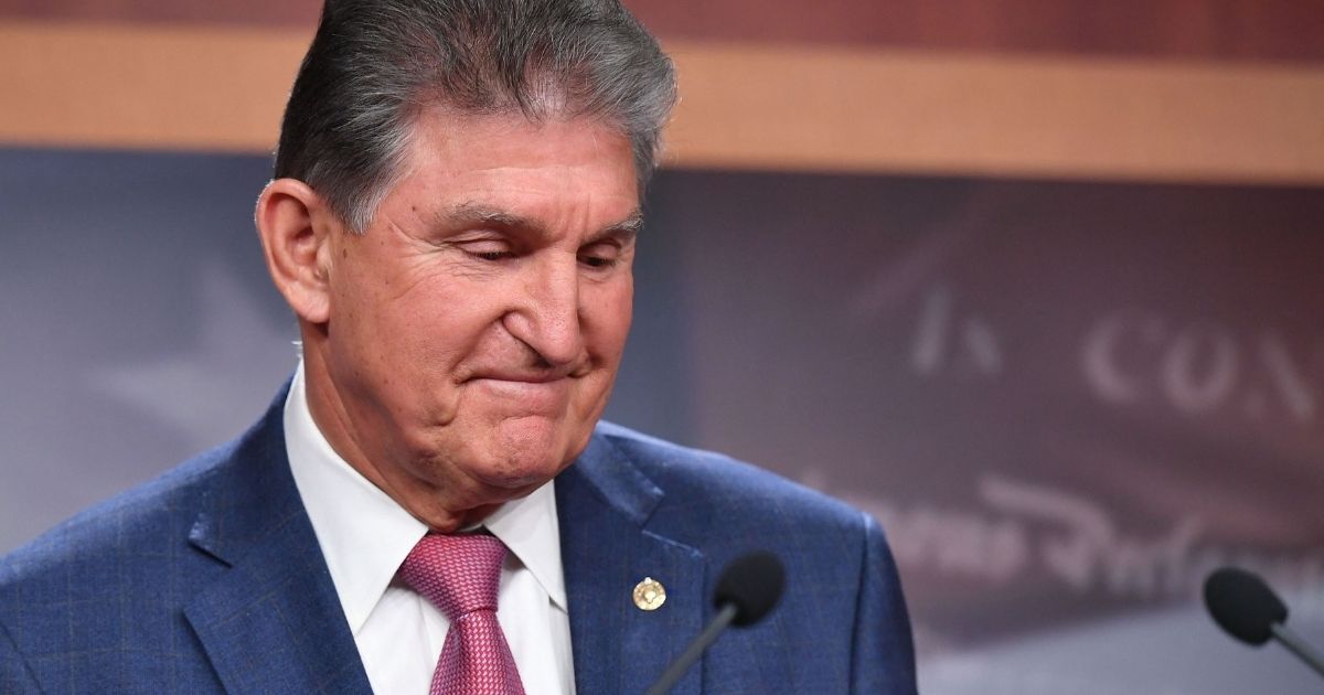 Sen. Joe Manchin of West Virginia looks on during a news conference on Capitol Hill in Washington, D.C., on Monday.
