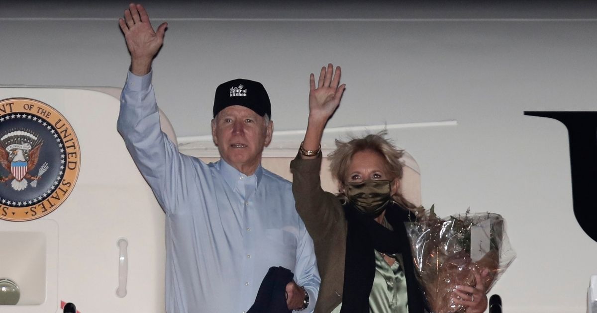 President Joe Biden and First Lady Jill Biden wave from the steps of Air Force One on Tuesday night before boarding the plane at Andrews Air Force Base, Maryland, to head to Nantucket, Massachusetts, for Thanksgiving.