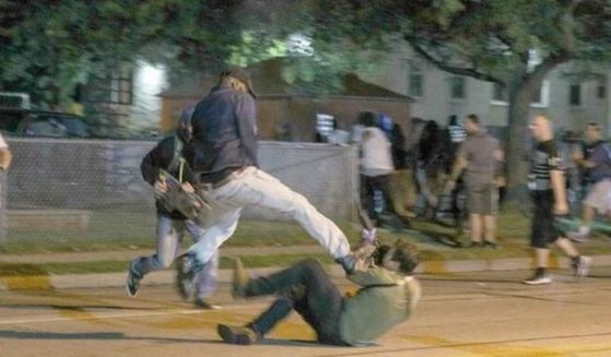 An unidentified man kicks Kyle Rittenhouse in the face during the rioting in Kenosha, Wisconsin, on Aug. 25, 2020.