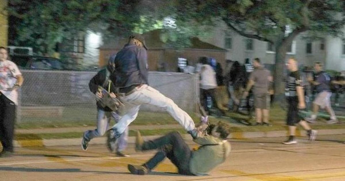 An unidentified man kicks Kyle Rittenhouse in the face during the rioting in Kenosha, Wisconsin, on Aug. 25, 2020.