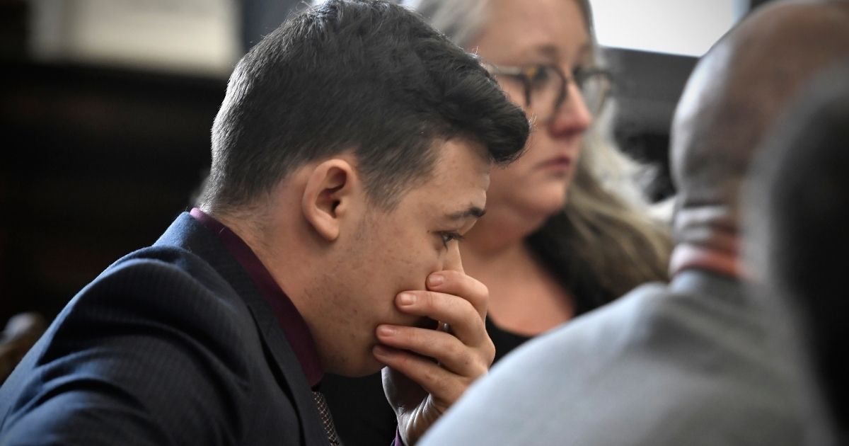 Kyle Rittenhouse puts his hand over his face as he is found not guilty on all counts at the Kenosha County Courthouse on Friday in Kenosha, Wisconsin.
