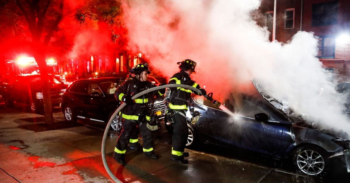 New York City firefighters put out a car fire in Brooklyn on July 1, 2020.