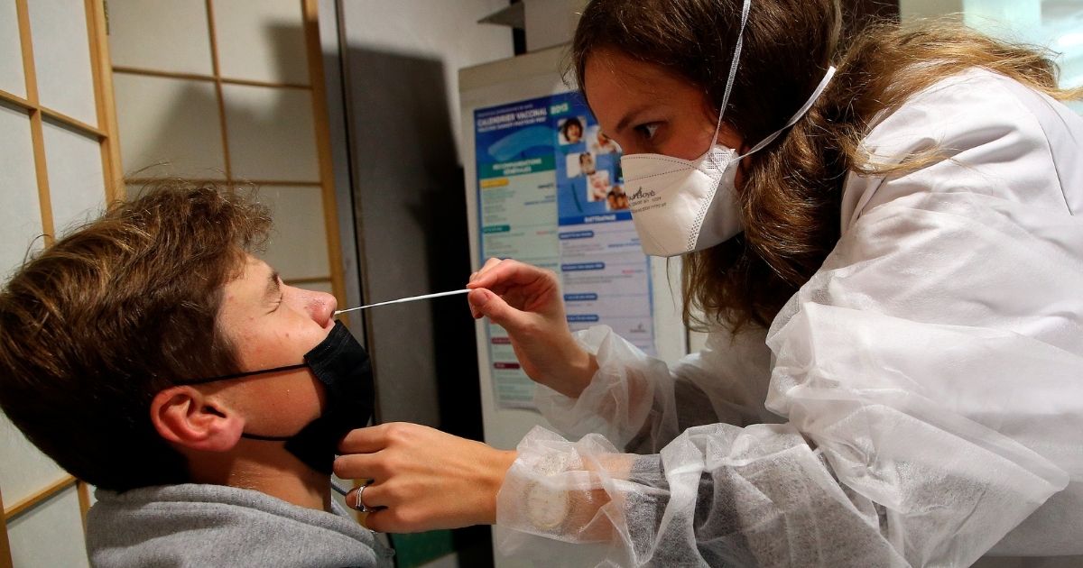 A pharmacist in Bayonne, France, gives a patient a nasal swab Covid test on Oct. 15.