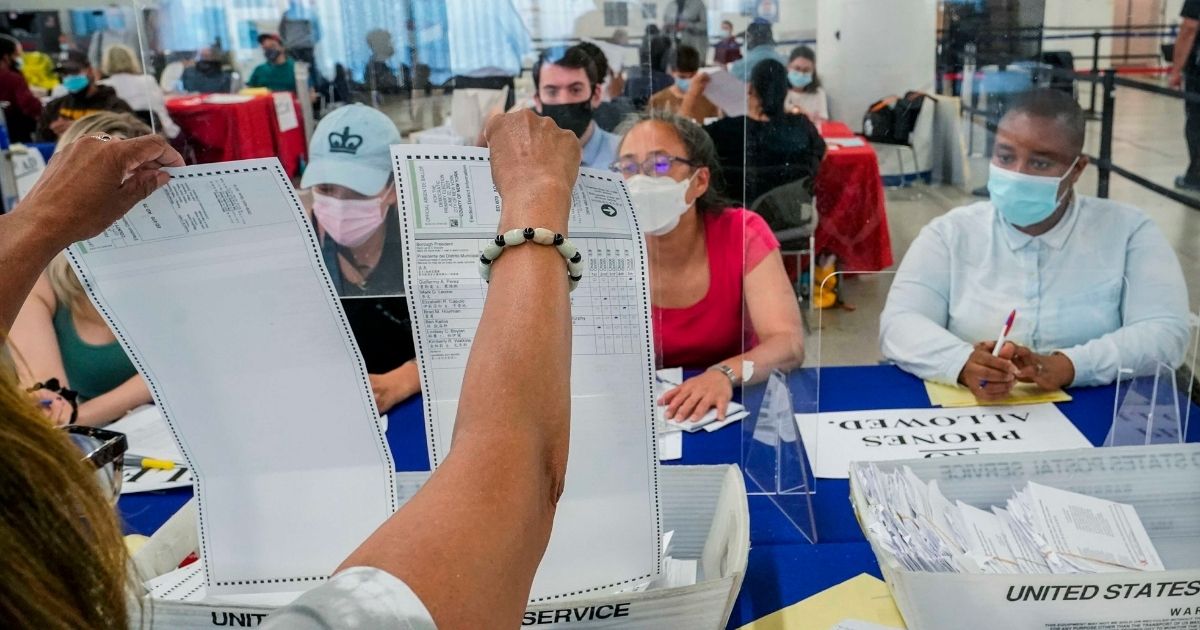 New York voters are shown a primary election absentee ballot by a New York City Board Election staff member on July 2.
