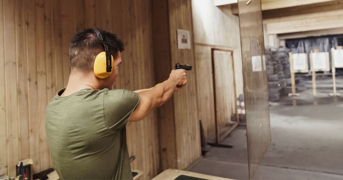 This stock image shows a man aiming a pistol at indoor targets. The Supreme Court is poised to issue a ruling on Second Amendment rights of Americans.