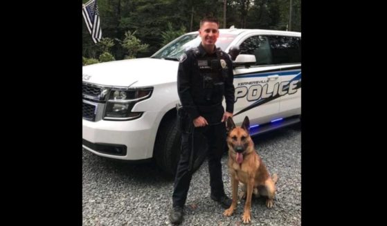 Officer Sean Houle with the Kernersville Police Department in North Carolina poses with his K9 partner.