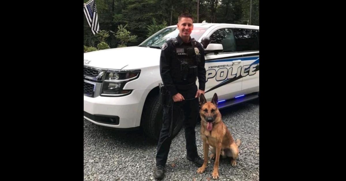 Officer Sean Houle with the Kernersville Police Department in North Carolina poses with his K9 partner.