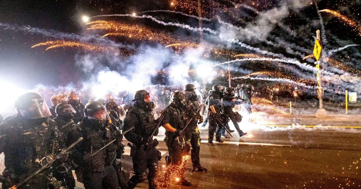 Portland police officers attempt to quell a riot in Portland, Oregon, on Sept. 5, 2020, using chemical irritants and crowd control munitions.