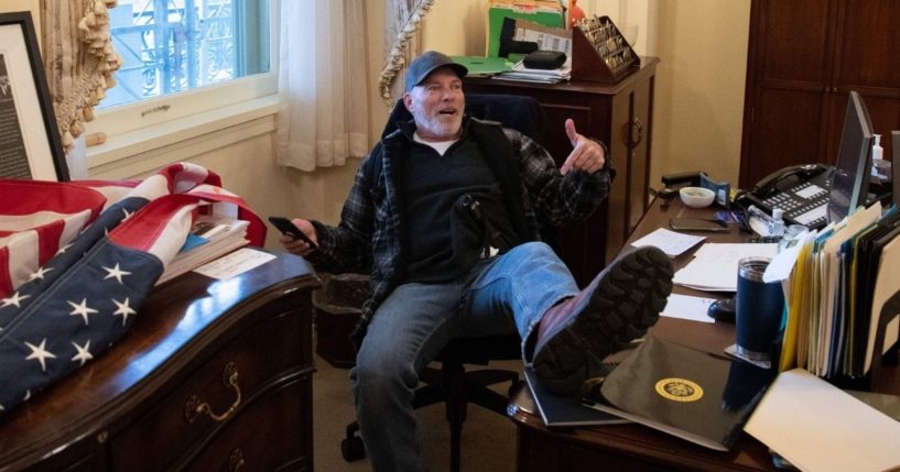 Richard Barnett, a supporter of former President Donald Trump, sits inside the office of Speaker of the House Nancy Pelosi as he protests inside the U.S. Capitol in Washington, D.C., on Jan. 6.