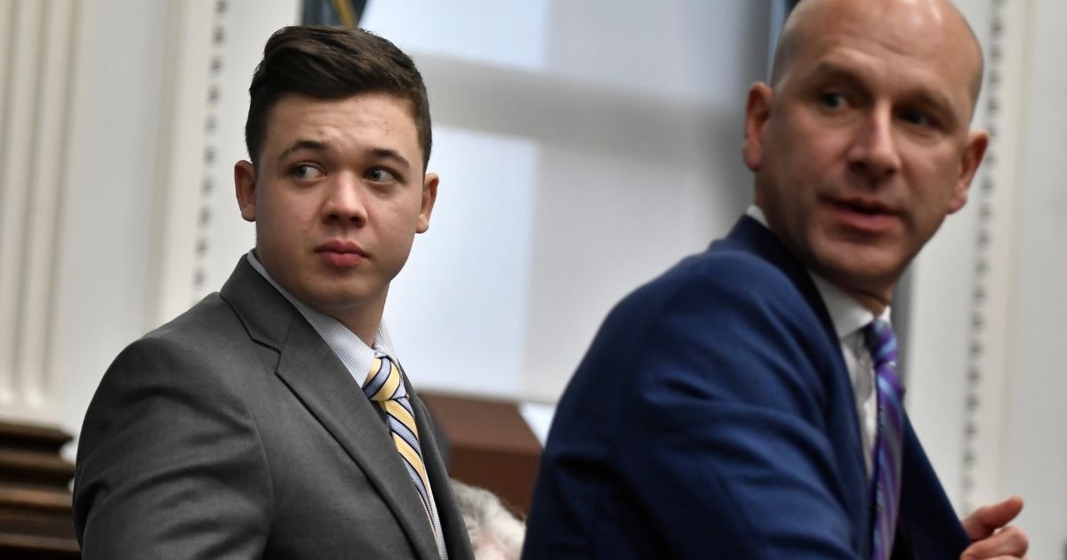 Kyle Rittenhouse, left, and his attorney Corey Chirafisi stand up after meeting with Judge Bruce Schroeder for questions on video the jury has asked for while they deliberate during Kyle Rittenhouse's trial at the Kenosha County Courthouse on Wednesday in Kenosha, Wisconsin.