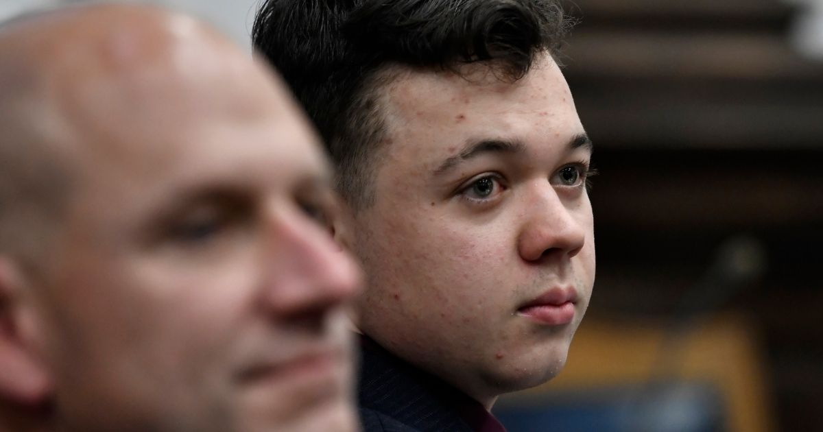 Kyle Rittenhouse, right, and his attorney Corey Chirafisi listen during the trial at the Kenosha County Courthouse in Wisconsin .last week. Jury deliberations are scheduled to begin this week. Twitter has been suspending users who defend Rittenhouse's innocence, but not those of users who claim the teen is guilty of murder.
