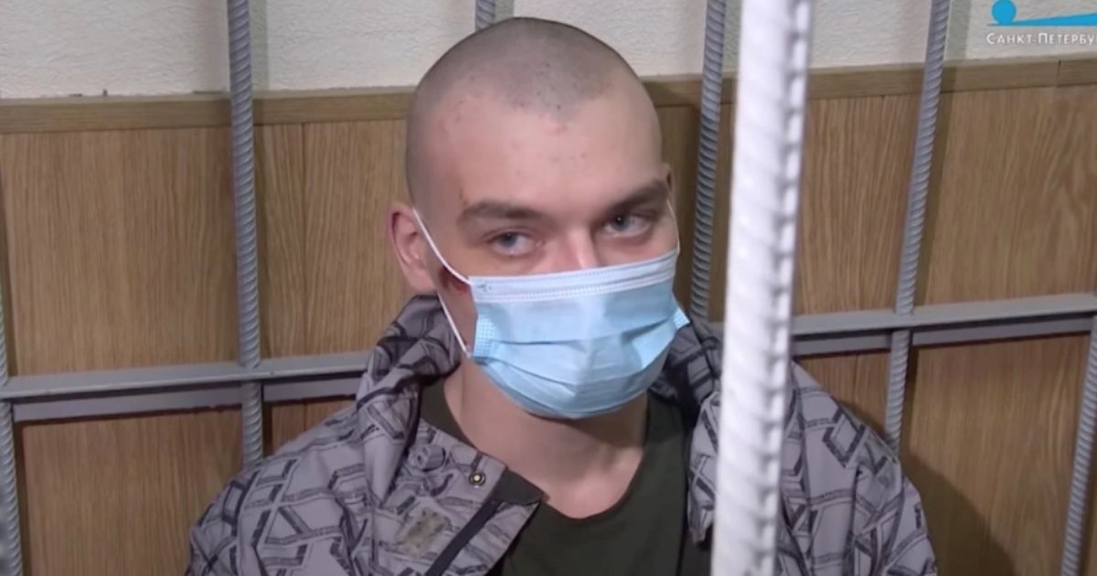 Yegor Komarov, 23, appeared in a court hearing after a decapitated body was thrown from the trunk of a car he was in as it crashed into a fence.