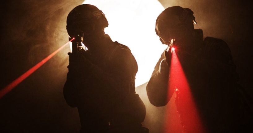 This stock image shows a SWAT team entering a room, with laser pointers visible. One woman issued a statement saying her home was targeted by an FBI SWAT team following her husband's presence at the Capitol on Jan. 6.