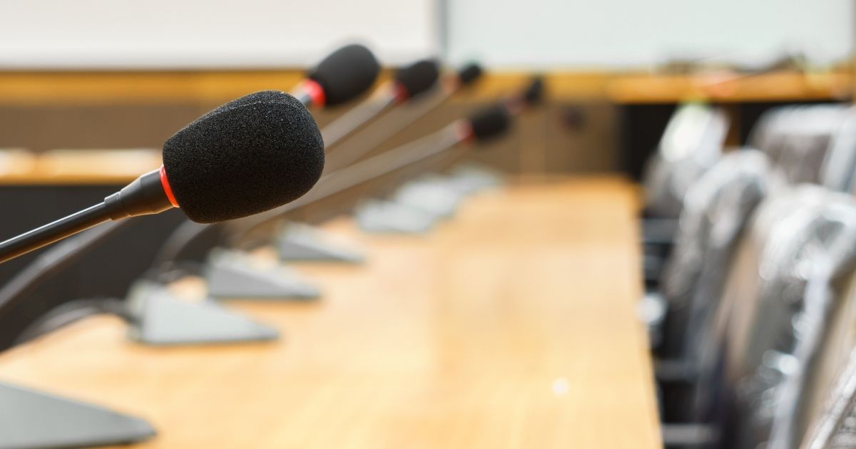 A desk at a school board meeting room is pictured in the stock image above.