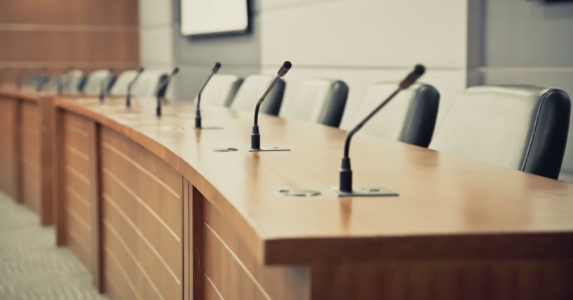 A school board meeting room is pictured in the stock image above.