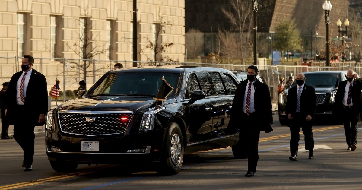 Secret Service agents protect President Joe Biden's motorcade during the abbreviated parade after his inauguration on Jan. 20 in Washington, D.C.