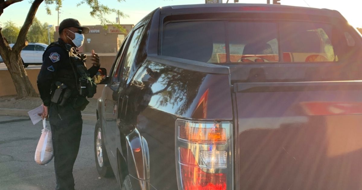 Officer Jason Flam with the Mesa Police Department surprises pulled-over drivers with turkeys, rather than tickets.