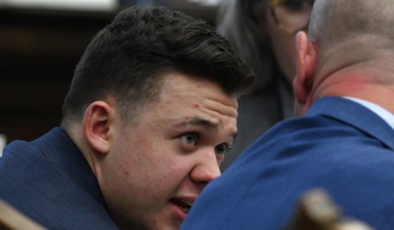 Kyle Rittenhouse talks with attorney Corey Chirafisi as the state argues against a defense motion for a mistrial because of prosecutorial misconduct during his trial at the Kenosha County Courthouse on Wednesday, in Kenosha, Wisconsin.