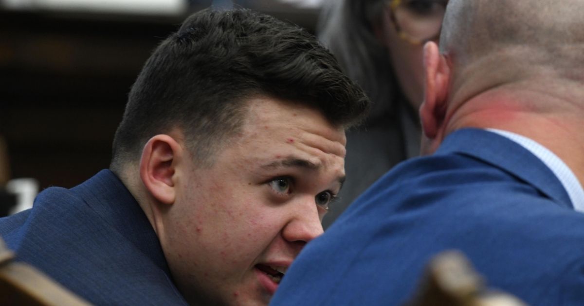 Kyle Rittenhouse talks with attorney Corey Chirafisi as the state argues against a defense motion for a mistrial because of prosecutorial misconduct during his trial at the Kenosha County Courthouse on Wednesday, in Kenosha, Wisconsin.