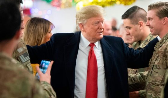 Then-President Donald Trump and First Lady Melania Trump greet members of the US military during an unannounced trip to Al Asad Air Base in Iraq on Dec. 26, 2018.