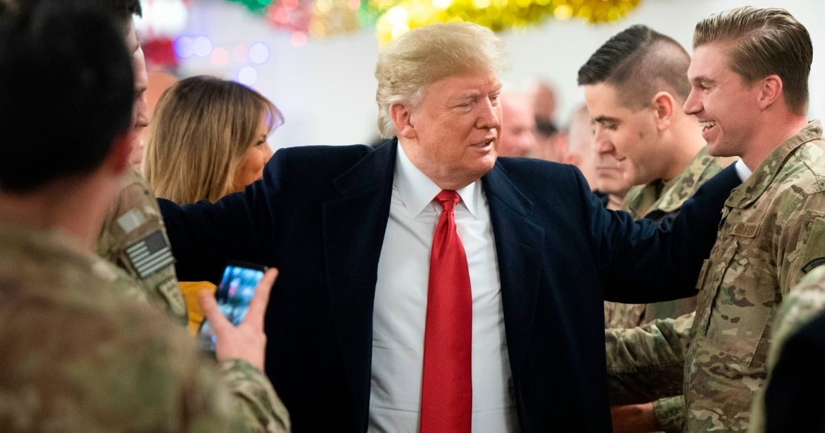 Then-President Donald Trump and First Lady Melania Trump greet members of the US military during an unannounced trip to Al Asad Air Base in Iraq on Dec. 26, 2018.