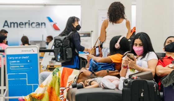 People wait outside of an American Airlines check-in counter at the George Bush Intercontinental Airport in Houston, Texas, on Aug. 5.