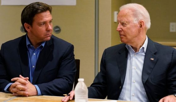 President Joe Biden, looking at Florida Gov. Ron DeSantis on July 1 during a briefing in Miami on the condo tower that collapsed in Surfside on June 24, has imposed COVID vaccine and testing mandates that DeSantis strongly opposes.