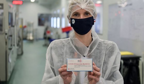 French Junior Industry Minister Agnes Pannier-Runacher holds a box of Moderna vaccine as she visits a pharmaceutical plant in Monts on April 22, 2021.