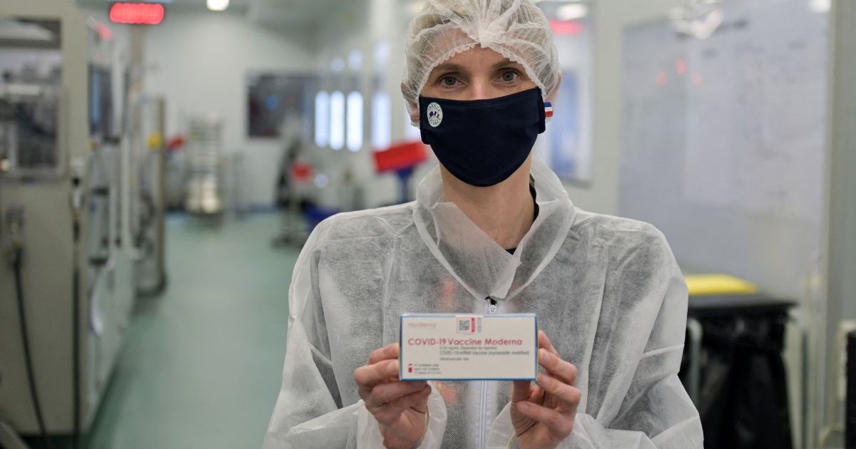 French Junior Industry Minister Agnes Pannier-Runacher holds a box of Moderna vaccine as she visits a pharmaceutical plant in Monts on April 22, 2021.