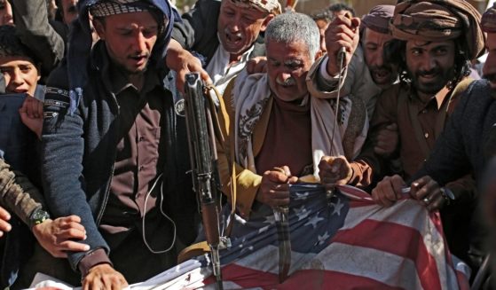 Supporters of Yemen's Houthi terrorist group desecrate a representation of an American flag during a demonstration outside the shuttered U.S. Embassy in Sanaa, Yemen, in January.