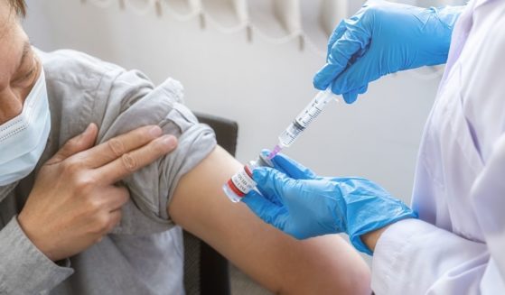 A man receives a COVID-19 vaccination shot.