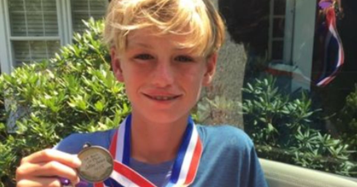Oakley Debbs holds a medal he earned before his death in 2016.