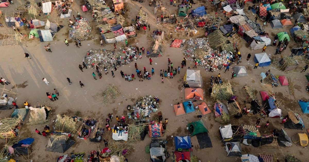 Migrants, many from Haiti, are seen at an encampment along the Del Rio International Bridge near the Rio Grande in Del Rio, Texas, on Sept. 21, 2021.