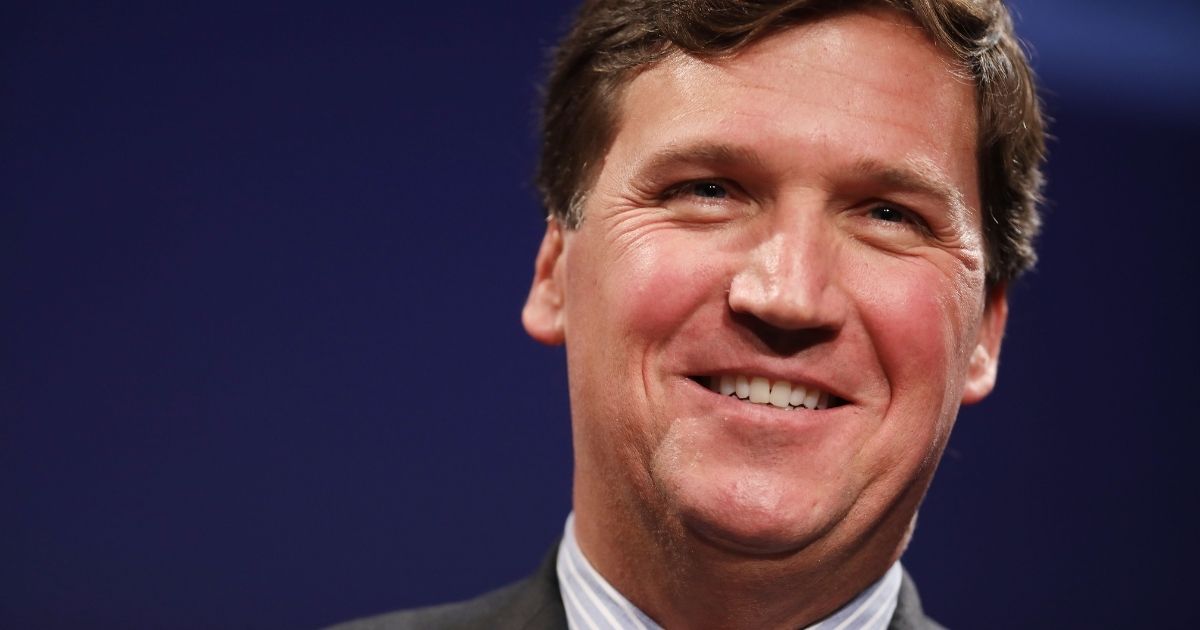 Fox News host Tucker Carlson, seen discussing 'Populism and the Right' during an ideas summit in Washington, D.C., in 2019, says it's 'great news' that contributors Jonah Goldberg and Steve Hayes are leaving Fox News.