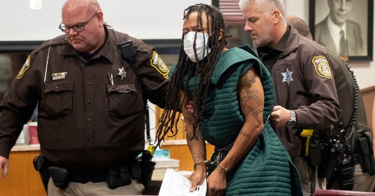 Darrell Brooks is escorted out of Waukesha County Court in Wisconsin by law enforcement on Tuesday, Nov. 23, 2021. Brooks was charged with five felony counts of first-degree intentional homicide in a Christmas parade massacre in Waukesha two days earlier.
