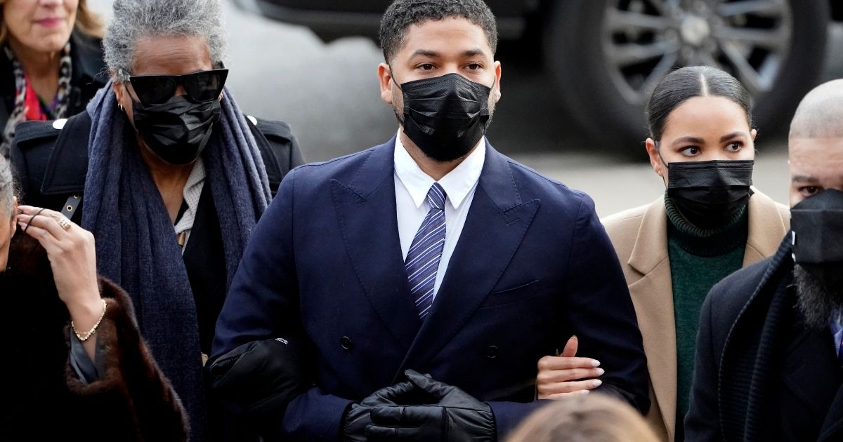 Actor Jussie Smollett walks with family members as they arrive at the Leighton Criminal Courthouse in Chicago on Nov. 29, 2021, for jury selection at his trial. Smollett is accused of lying to police when he reported he was the victim of a racist, anti-gay attack in downtown Chicago nearly three years ago.