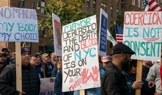 People protest the COVID-19 vaccine mandate for municipal workers during a demonstration at Gracie Mansion in New York City on Thursday.