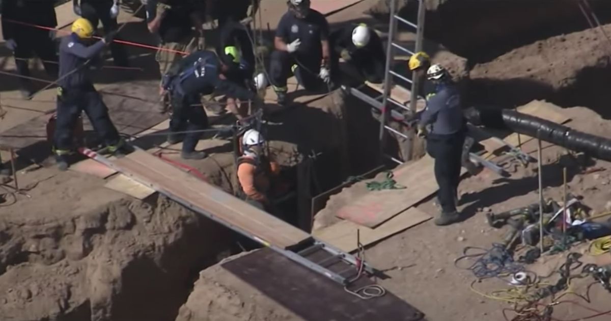 Rescue crews pulled two construction workers out of a 25-foot trench in Scottsdale, Arizona, on Monday.